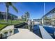 View of boat lift on canal with house in background, providing easy access to the water and boating activities at 1801 Los Alamos Dr, Punta Gorda, FL 33950