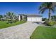 Beautiful home with a three car garage, landscaped yard and a paver driveway at 1801 Los Alamos Dr, Punta Gorda, FL 33950