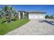 Beautiful home with a three car garage, landscaped yard and a paver driveway at 1801 Los Alamos Dr, Punta Gorda, FL 33950