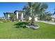 Beautifully landscaped front yard with a large palm tree and well-maintained lawn on a sunny day at 1801 Los Alamos Dr, Punta Gorda, FL 33950
