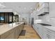 Open kitchen with a large island, stainless appliances, gas cooktop, and wood-look flooring at 1801 Los Alamos Dr, Punta Gorda, FL 33950