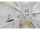 Laundry room with stainless sink, modern appliances, and ample cabinet space at 1801 Los Alamos Dr, Punta Gorda, FL 33950