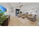 Spacious living room featuring a sectional sofa, wood floors, and open access to kitchen and patio at 1801 Los Alamos Dr, Punta Gorda, FL 33950