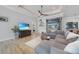 Comfortable living room with sectional sofa, wood floors, patio access, and entertainment center at 1801 Los Alamos Dr, Punta Gorda, FL 33950