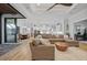 Expansive living room connecting to kitchen and dining area, featuring a sectional sofa and wood flooring at 1801 Los Alamos Dr, Punta Gorda, FL 33950