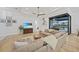 Relaxing living room with sectional sofa, wood floors, a TV, and an open patio view at 1801 Los Alamos Dr, Punta Gorda, FL 33950