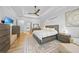 Light and airy main bedroom with wood-look floors and stylish neutral-toned furnishings at 1801 Los Alamos Dr, Punta Gorda, FL 33950