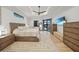 Bright main bedroom featuring wood-look flooring, stylish furniture, and pool views at 1801 Los Alamos Dr, Punta Gorda, FL 33950
