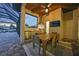 Covered outdoor kitchen features a stainless steel grill, refrigerator, and cozy dining area with ceiling fan at 1801 Los Alamos Dr, Punta Gorda, FL 33950
