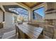 An inviting outdoor dining area with a built-in kitchen overlooking the pool and patio at 1801 Los Alamos Dr, Punta Gorda, FL 33950