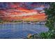 Picturesque waterfront view with boats docked along the pier under a vibrant and colorful sunset at 1801 Los Alamos Dr, Punta Gorda, FL 33950