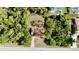 Aerial view of home showing lush landscaping, privacy, and a long driveway at 18335 Oxford Ave, Port Charlotte, FL 33948