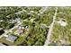 An aerial view showing a neighborhood with lush trees, homes, and a winding road at 18335 Oxford Ave, Port Charlotte, FL 33948