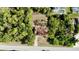 Aerial view of home showing lush landscaping, privacy, and a long driveway at 18335 Oxford Ave, Port Charlotte, FL 33948