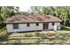 Back exterior view of home showing windows, patio and clay tile roof at 18335 Oxford Ave, Port Charlotte, FL 33948