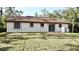 Back exterior view of home showing windows, patio and clay tile roof at 18335 Oxford Ave, Port Charlotte, FL 33948
