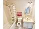 Bathroom featuring a tub-shower, sink, toilet, and white tiled floor at 18335 Oxford Ave, Port Charlotte, FL 33948