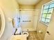 Bathroom featuring a shower, sink, and white tiled floor at 18335 Oxford Ave, Port Charlotte, FL 33948
