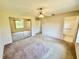 Bedroom featuring carpeted floors, mirrored closet, and ceiling fan at 18335 Oxford Ave, Port Charlotte, FL 33948