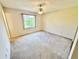 Bedroom with neutral carpet and a window providing natural light at 18335 Oxford Ave, Port Charlotte, FL 33948