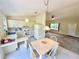Cozy kitchen featuring white appliances and cabinetry, adjacent to a dining area at 18335 Oxford Ave, Port Charlotte, FL 33948
