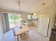 Cozy eat-in kitchen with ample counter space, sliding glass doors and natural light at 18335 Oxford Ave, Port Charlotte, FL 33948