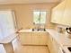 Bright kitchen featuring an eat-in counter, window, and classic white cabinets at 18335 Oxford Ave, Port Charlotte, FL 33948