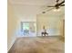 Open living space featuring plush carpeting and seamless flow into the dining area at 18335 Oxford Ave, Port Charlotte, FL 33948