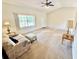Living room featuring a sofa, ottoman, and carpeted floors at 18335 Oxford Ave, Port Charlotte, FL 33948
