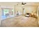 Bright living room with a ceiling fan and neutral decor flowing into the dining area at 18335 Oxford Ave, Port Charlotte, FL 33948