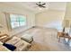 Living room featuring a sofa, ottoman, and carpeted floors at 18335 Oxford Ave, Port Charlotte, FL 33948