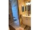 Bathroom featuring dual sinks, patterned wallpaper, and tiled walk-in shower at 2023 Lynx Run, North Port, FL 34288