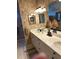 Bathroom with dual sinks, framed mirrors, and decorative lamps at 2023 Lynx Run, North Port, FL 34288