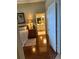 Inviting bedroom with wood floors featuring an ensuite bathroom and a cozy rug at 2023 Lynx Run, North Port, FL 34288