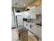 White kitchen with appliances and moveable center island at 2023 Lynx Run, North Port, FL 34288