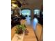 Open-concept dining and living room with tiled floor and lake views at 2023 Lynx Run, North Port, FL 34288