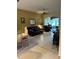 Comfortable living room features tile flooring, ceiling fan, and ample seating at 2023 Lynx Run, North Port, FL 34288