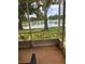 Screened-in brick patio offering serene water views and privacy at 2023 Lynx Run, North Port, FL 34288