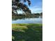 Scenic view of a serene pond reflecting the sky, surrounded by lush green grass at 2023 Lynx Run, North Port, FL 34288