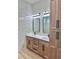 Bathroom featuring double sinks, framed mirrors, and natural wood cabinetry at 2089 Garnet St, North Port, FL 34288