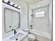 A vanity and toilet in a bathroom with marble tile in the shower at 2089 Garnet St, North Port, FL 34288