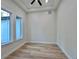 A bright bedroom features laminate floors, a ceiling fan and two windows at 2089 Garnet St, North Port, FL 34288