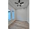 A bright bedroom features laminate floors, a ceiling fan and two windows at 2089 Garnet St, North Port, FL 34288
