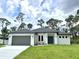 Beautiful one-story home with a well-manicured lawn and attached two-car garage at 2089 Garnet St, North Port, FL 34288