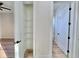 Open closet with wire shelving with view to hallway and bathroom at 2089 Garnet St, North Port, FL 34288
