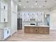 The kitchen boasts stainless appliances, custom cabinets, and a center island with bar seating at 2089 Garnet St, North Port, FL 34288