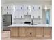 White cabinets offer ample storage space with stainless steel refrigerator at 2089 Garnet St, North Port, FL 34288