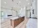 Stylish island with quartz countertop offers seating and storage with stainless dishwasher at 2089 Garnet St, North Port, FL 34288