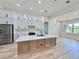 Gourmet kitchen features a large island, stainless steel appliances, and custom lighting fixtures at 2089 Garnet St, North Port, FL 34288