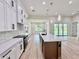 Open concept kitchen with quartz countertops and a breakfast bar island overlooking the living area at 2089 Garnet St, North Port, FL 34288